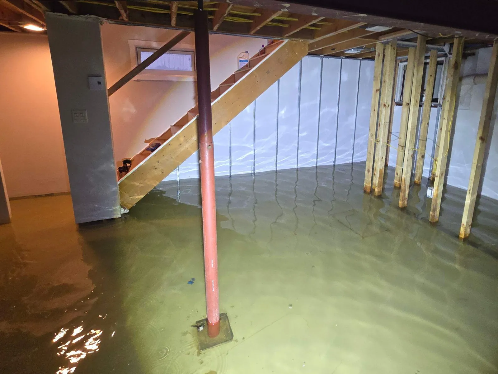 Flooded basement with standing water before Aided Water Damage Restoration
